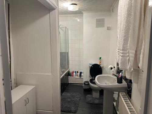 a white bathroom with a toilet and a sink at Seaside Stay Sleeps 6 with Pets in Great Yarmouth