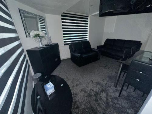 a living room with a couch and chairs and a table at Seaside Stay Sleeps 6 with Pets in Great Yarmouth