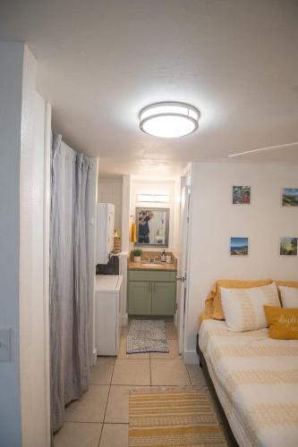 a living room with a couch and a bathroom at Ground Level Beachfront Studio in Hauula