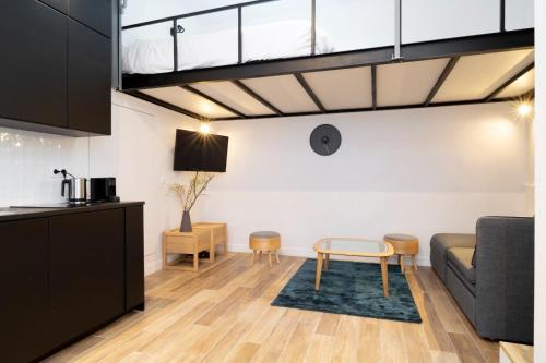 a living room with a couch and a table at Studio 5 mn from Arc de triomphe - Champs-Élysées in Paris