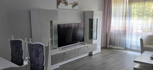 a living room with a flat screen tv in a cabinet at Ferienwohnung in Neuss nahe Düsseldorf in Hamm