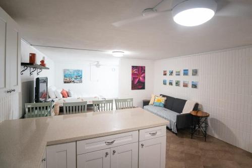 a kitchen and living room with a couch at Beach & Country Beachfront Studio in Hauula