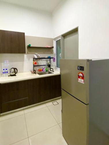 a kitchen with a stainless steel refrigerator in it at 2 Bedrooms Suites at Mesahill Nilai with Mall by D'KAY HOMES, near USIM KLIA in Nilai
