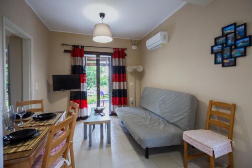 a living room with a couch and a table at Aggerikos Relax House in Ayios Kirikos