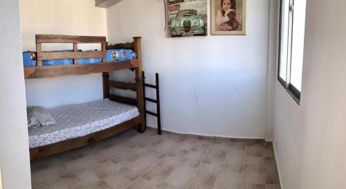 a room with two bunk beds and a dog laying on the floor at Adonai El Roi in Juan de Acosta