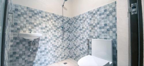 a bathroom with a toilet and a sink at Pacific Guesthouse in Ubay