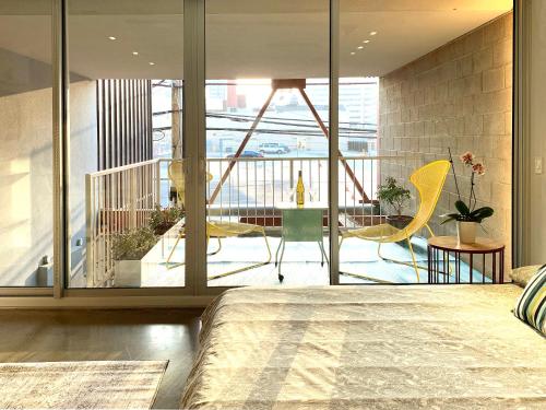 a bedroom with a bed and a view of a balcony at Loft Suite with private patio in Art Tower in Philadelphia