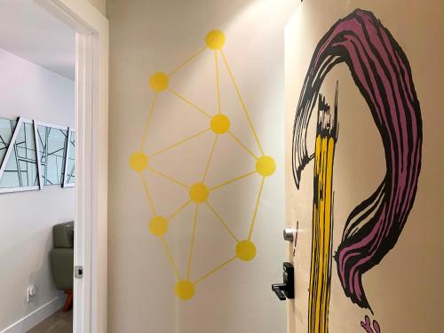 a room with a mirror and a surfboard on the wall at Loft Suite with private patio in Art Tower in Philadelphia