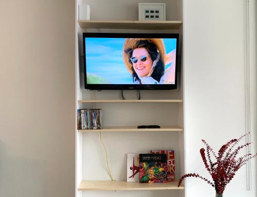 a television in a shelf in a living room at Loft Suite with private patio in Art Tower in Philadelphia