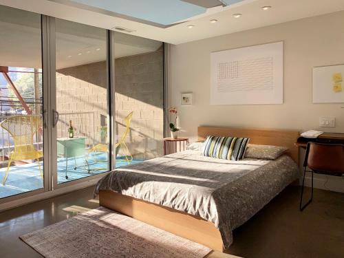 a bedroom with a large bed and a balcony at Loft Suite with private patio in Art Tower in Philadelphia