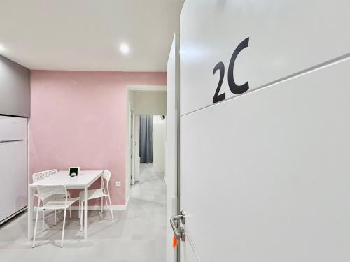 a room with a table and a pink wall at SÉ - BRAGA Lounge Suites COLLECTION BY PERPETUAL RELAX in Braga