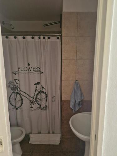 a bathroom with a shower curtain with a bicycle on it at Posada de campo LA AMADA in San Pedro