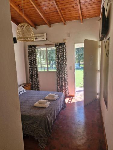 a bedroom with a bed with two towels on it at Posada de campo LA AMADA in San Pedro