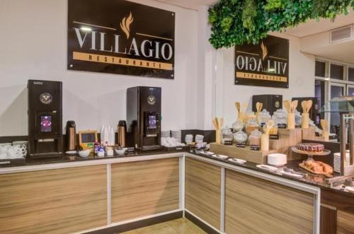 a restaurant with a counter with a coffee shop at Flat in Wyndham Paulista com estacionamento in Sao Paulo