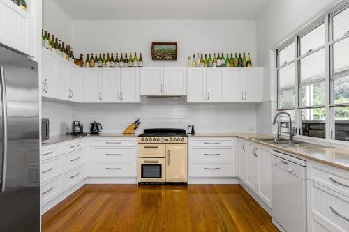 a kitchen with white cabinets and a stove top oven at Luxury Farm Homestead & Animal Sanctuary, Hot Tub in The Pocket