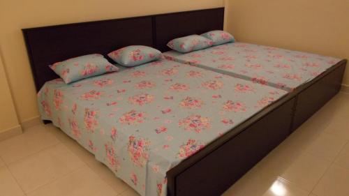 a bedroom with a bed with pink flowers on it at Bedroom with Pantry in Mount Lavinia