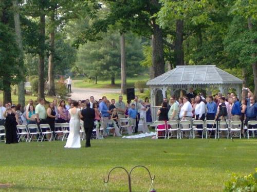 a bride and groom are married in front of a crowd at The Garden Inn Bed & Breakfast at Bee Rock in Monterey