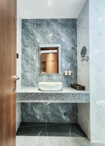 a bathroom with a sink and a mirror at Chill House in Quy Nhon