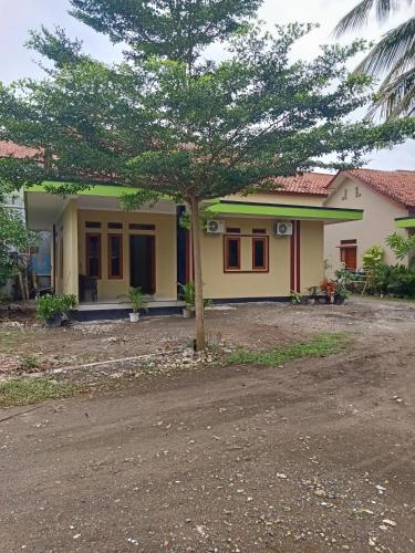 a small house with a tree in front of it at Griya PAS Pangandaran in Pangandaran