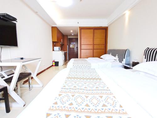 TV a/nebo společenská místnost v ubytování Guangzhou Uhome Service Apartment