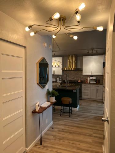 a kitchen with a door open to a kitchen with a table at McCall Art House in McCall