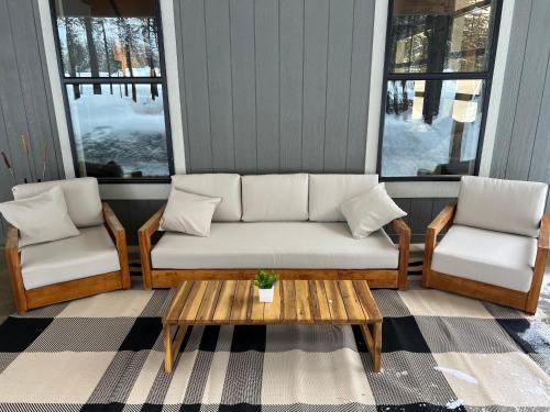 a porch with a couch and two chairs and a table at McCall Art House in McCall