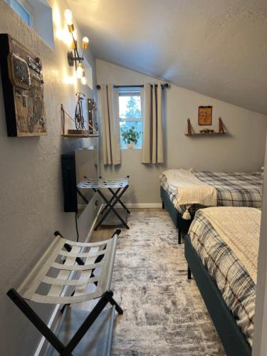 a room with two beds and a chair in it at McCall Art House in McCall