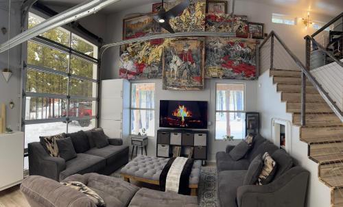 a living room with couches and a fireplace at McCall Art House in McCall