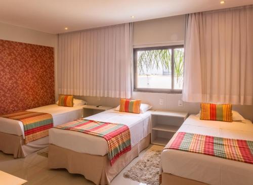 Säng eller sängar i ett rum på Hotel Girassol Plaza