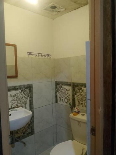 a bathroom with a toilet and a sink at Naramalan Inn in San Vicente