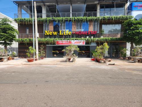 a building with a new life innovation sign on it at New Life Homestay in Phan Thiet