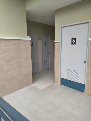 a hallway with four doors in a building at The Solace Place- Near Nuvali Sta Rosa Laguna in Bayabasan