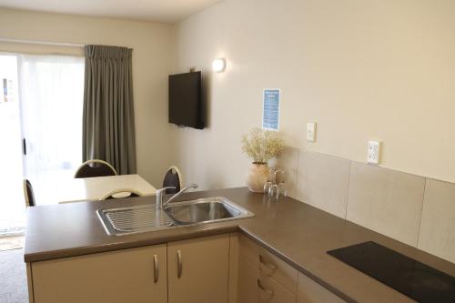 a kitchen with a sink and a counter at BK's Fountain Court Motel in Napier