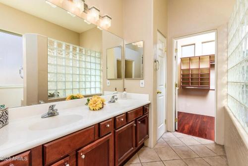 a bathroom with a sink and a large mirror at Where Luxury Meets Serenity Your Dream Getaway in Chandler