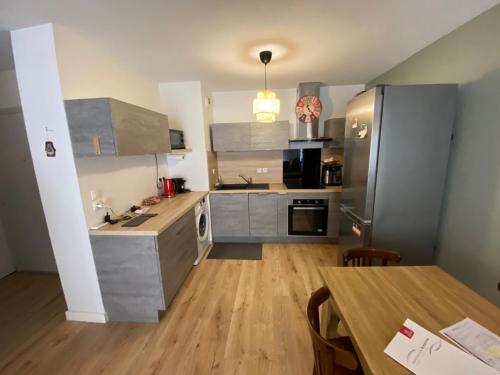 Il comprend une cuisine équipée d'appareils en acier inoxydable et du parquet. dans l'établissement Charmant 3 pièces à Sète avec climatisation et parking - FR-1-338-601, à Sète