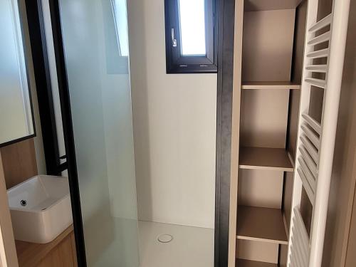 a small bathroom with a walk in closet at Chalet 3 chambres avec terrasse calme à Saint-Romain-de-Benet - FR-1-783-48 in Saint-Romain-de-Benet