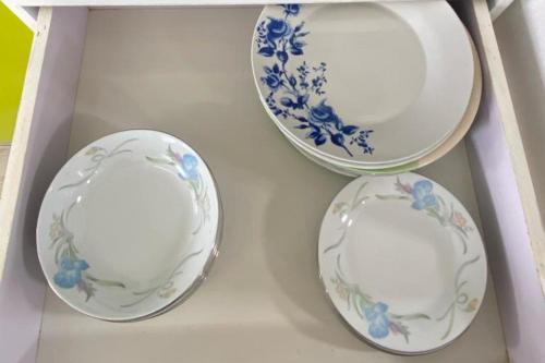 three plates in a white drawer with blue flowers at Le Botanic Oasis 3 beds summer vacation private villa with private pool and garden albion in Albion