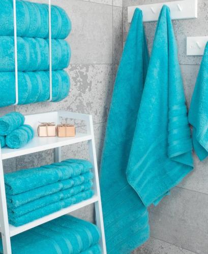 a bunch of blue towels sitting on a shelf at Eat well Sleep Well in Larnaca