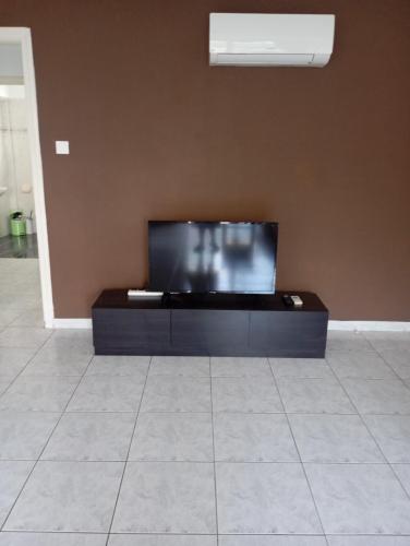 a flat screen tv sitting on top of a wall at Eat well Sleep Well in Larnaca