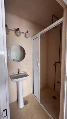 a bathroom with a sink and a mirror at Burgos Studio in Cancún