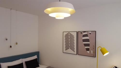 a room with a lamp and a picture on the wall at Adellia Pension in Gyeongju