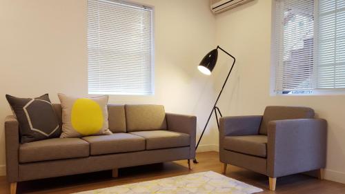 a living room with a couch and a chair at Adellia Pension in Gyeongju