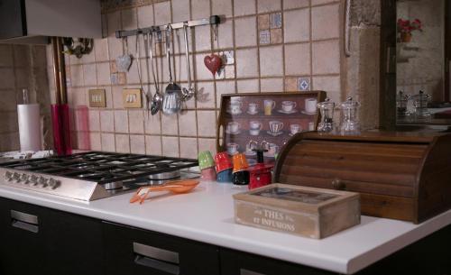 a kitchen counter with a stove and a box on it at Antica Dimora Julia in Spello