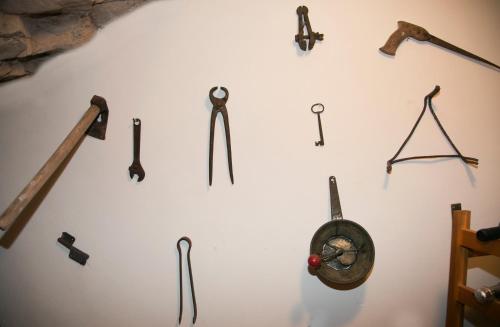 a wall with many different kinds of tools on it at Antica Dimora Julia in Spello