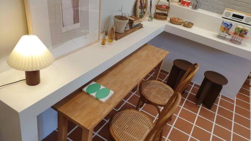 a kitchen with a table and chairs and a counter at Adellia Pension in Gyeongju