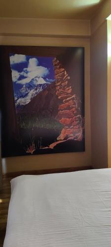a large painting on the wall of a bedroom at Sabila Boutique Hotel in Kathmandu