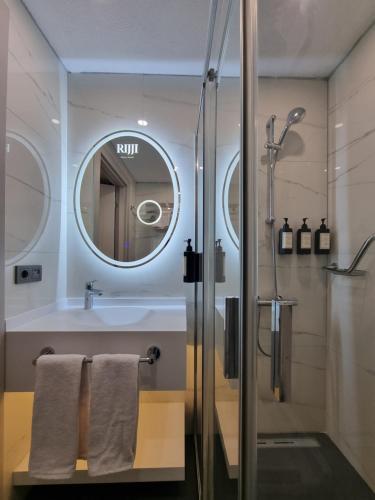 a bathroom with a shower and a sink and a mirror at RIJJI HOTEL ISTANBUL OLD CiTY in Istanbul
