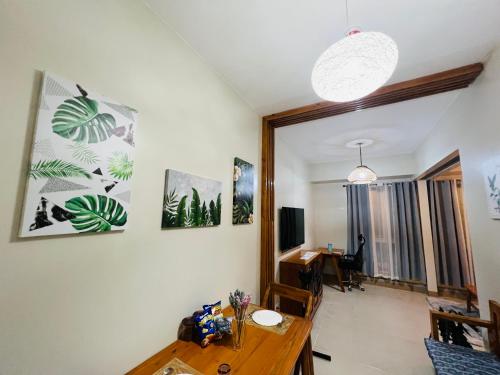 a dining room with a table and a desk at The Palladium Megaworld in Iloilo City