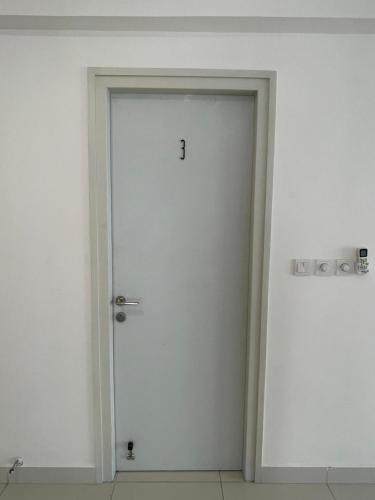 a white door with a number one on it at Clove Beach Hulhumale in Male City