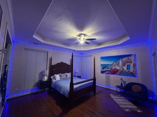 a bedroom with a bed with blue lights on it at Stay by Kemah Boardwalk- Diamond Retreat in Kemah
